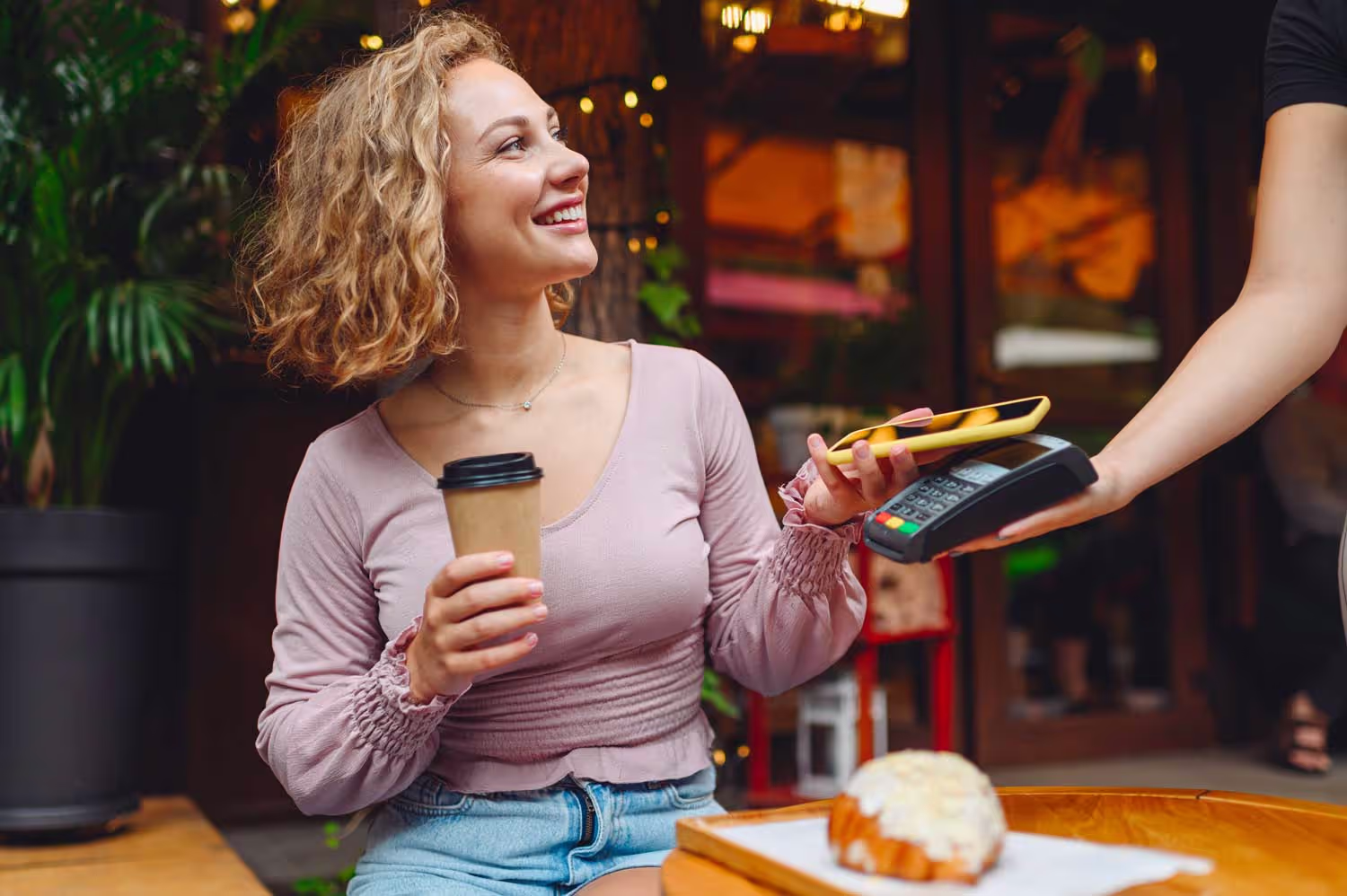 Small business owner taking a contactless payment